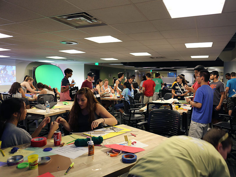 A room full of students all building low-fidelity prototypes during Design Bloc class.