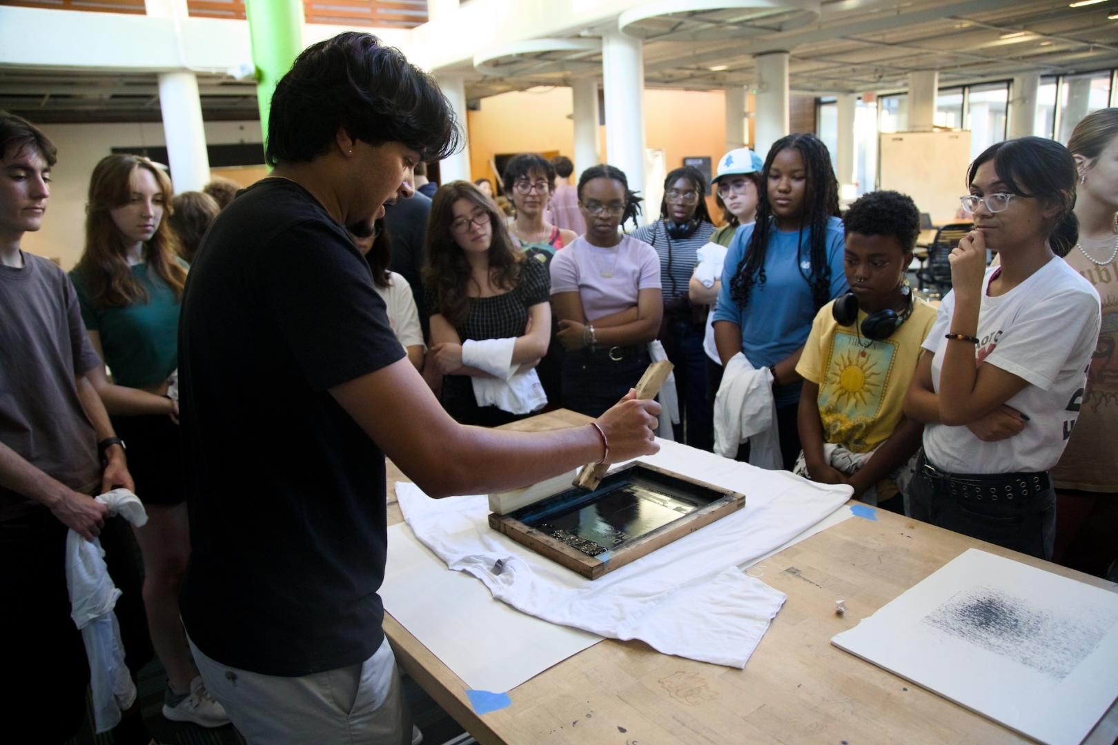 Student demonstrates silkscreening technique
